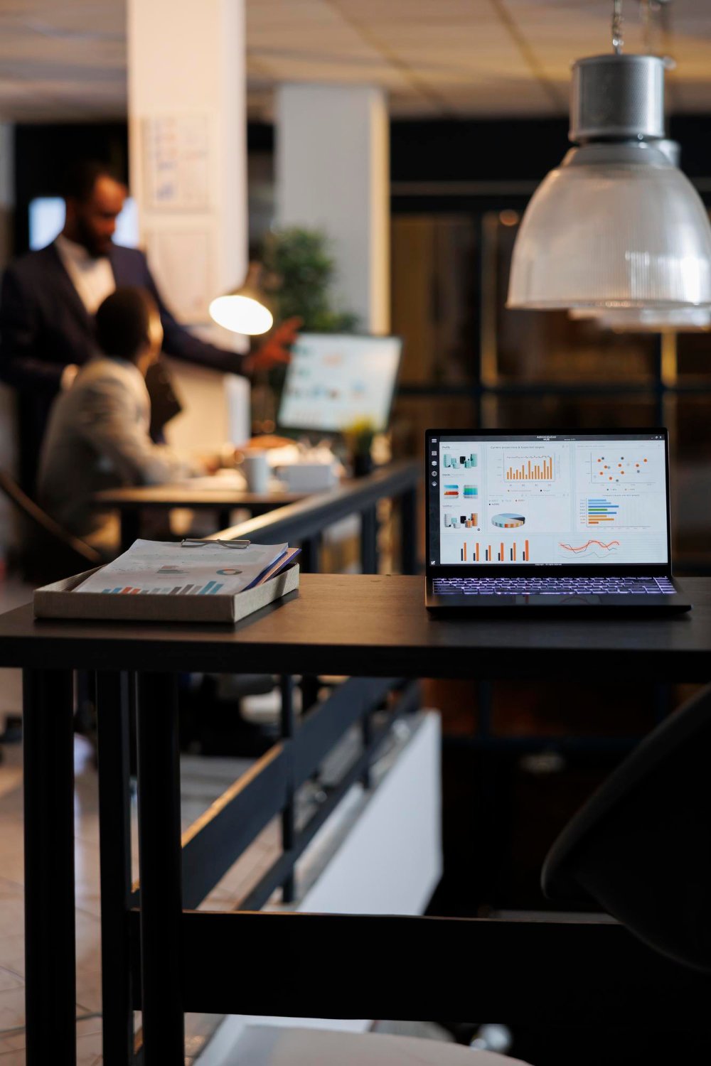 A laptop displaying business dashboards on a desk